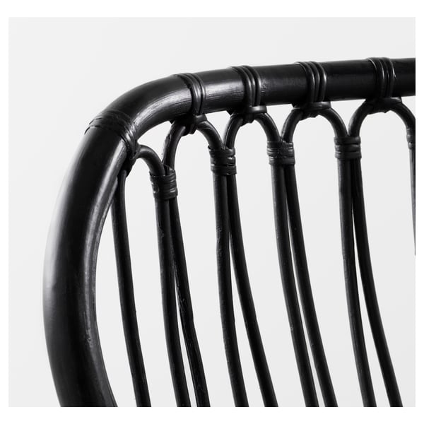 Black rattan chair with curved back and vertical slats, intricate weaving pattern, sturdy construction.