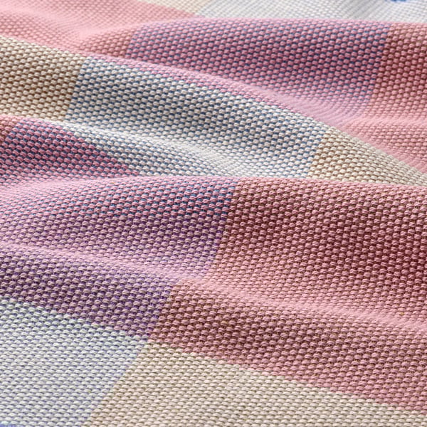 Colorful, woven table runner. Soft cotton texture. Stripes in blue, pink, beige. Vibrant, decorative design.