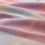Colorful, woven table runner. Soft cotton texture. Stripes in blue, pink, beige. Vibrant, decorative design.