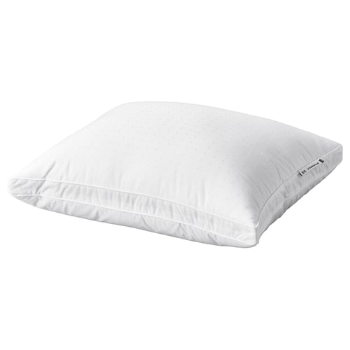 A white STRANDMOLKE pillow with a supportive core and soft outer filling, featuring double piping and a dobby-weave cotton cover.