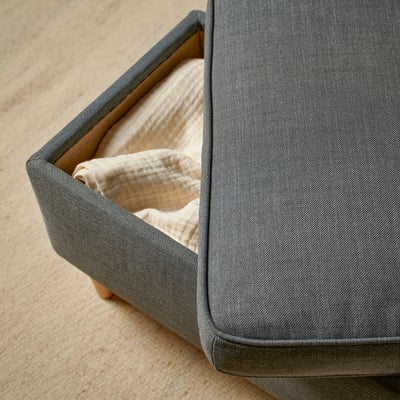 STRANDMON footstool with storage. Grey fabric, open compartment.