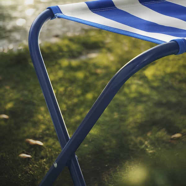 Blue and white striped mesh chair, sturdy metal frame outdoors.