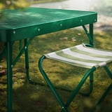 Green metal outdoor table and chair set, ideal for camping or garden use.
