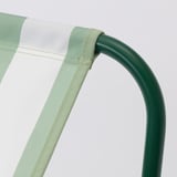 Close-up of a green powder-coated metal armrest and durable polyester fabric with light stitching details on a high-quality outdoor chair.