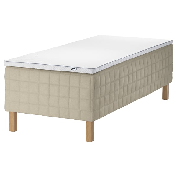 IKEA STUVLAND bed: cream, wooden base, rectangular, padded.