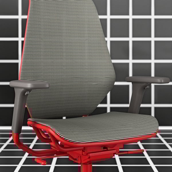 STYRSPEL red gaming chair, mesh back and seat, adjustable armrests, grey tiled wall.