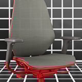 STYRSPEL red gaming chair, mesh back and seat, adjustable armrests, grey tiled wall.