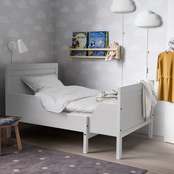 White SUNDVIK kids bed, books, toy, yellow dress; cozy room.