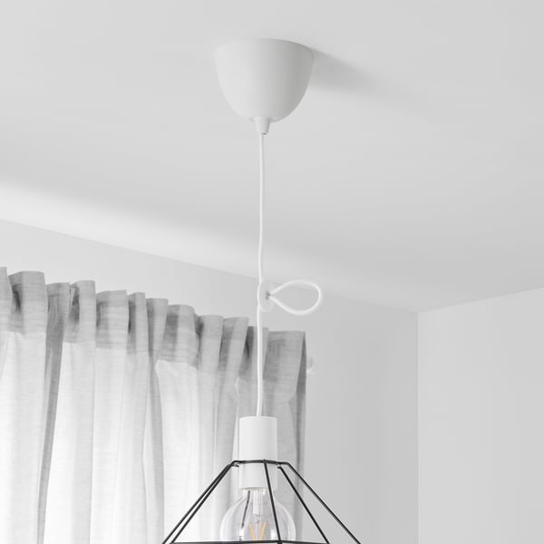 White pendant lamp cord set with a bulb and metal shade hangs from ceiling.