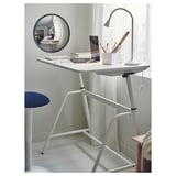 Small white desk setup with mirror, stool, lamp, and laptop.