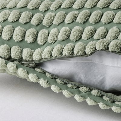 Pillow cover with soft, textured light green pom-poms, zip closure, recycled polyester.