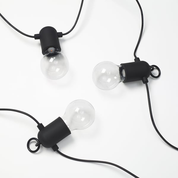 Three sleek black light bulbs, minimalist design on white background.