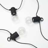 Three sleek black light bulbs, minimalist design on white background.