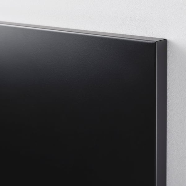 Close-up of sleek, black magnetic board with smooth powder-coated metal surface, neatly mounted on a clean wall.