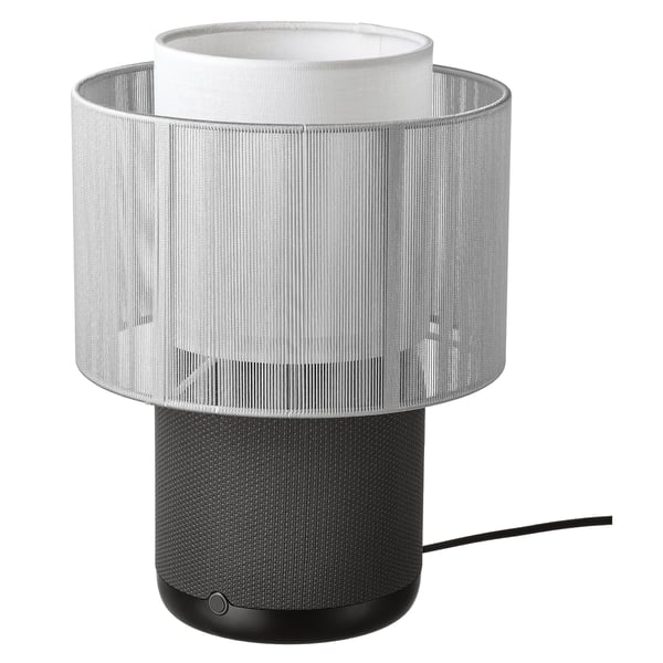 This image displays a white SYMFONISK table lamp with built-in wifi speaker, sleek design, cylindrical shape and textured fabric shade.