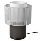 This image displays a white SYMFONISK table lamp with built-in wifi speaker, sleek design, cylindrical shape and textured fabric shade.