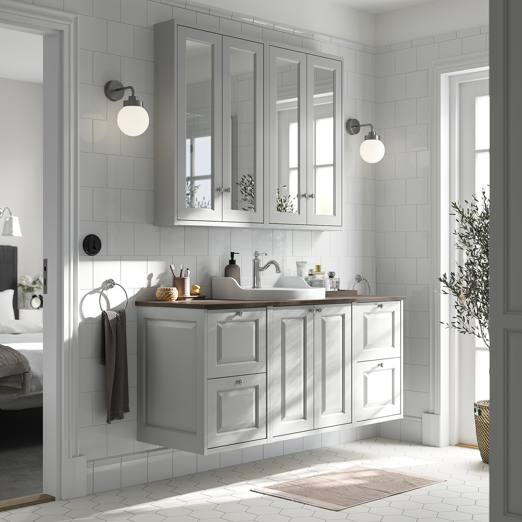 Modern bathroom with grey TÄNNFORSEN vanity, mirror cabinets, & natural light.