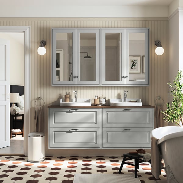Gray TÄNNFORSEN bathroom vanity with double sink, ample storage, wall mirrors, and spherical lights. Hexagon floor, modern elegance.