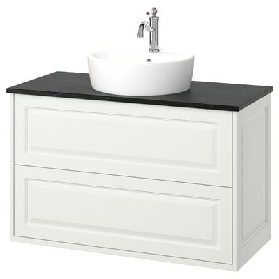 White TÄNNFORSEN vanity with round white basin, chrome faucet, dark countertop. Classic, wall-mounted design.