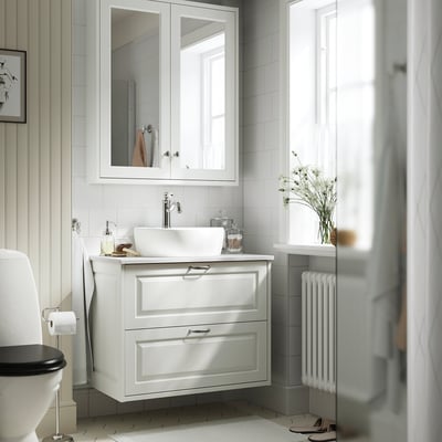Modern bathroom with TÄNNFORSEN white cabinet and sink, classic bevelled edges, wall-mounted, spacious and well-lit.