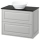Modern white bathroom vanity with black countertop and bowl-shaped sink.