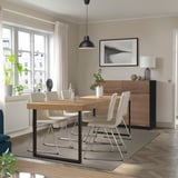 Modern dining area with TARSELE oak table, seating 4-6, extended. Metal legs, minimalist art, white curtains.
