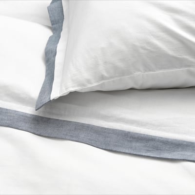 White bedding set by TÅTELSMYGARE. Made of 100% organic cotton. Includes duvet cover and pillowcase.