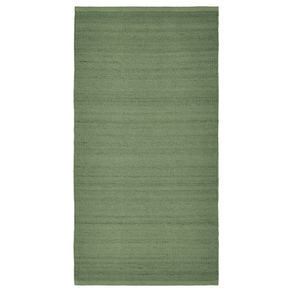 Green rectangular wool rug with melange pattern.