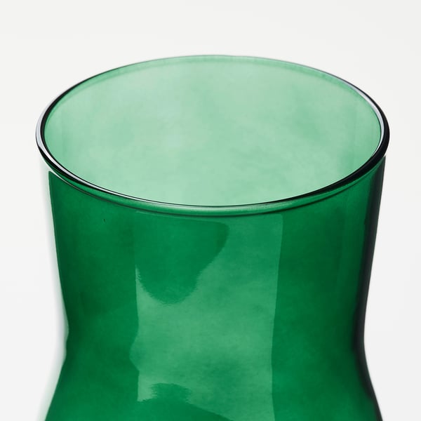 A sleek, dark green glass vase with smooth, curved sides and a wide opening.
