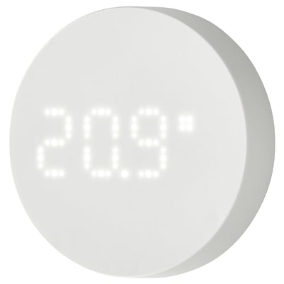 Round white smart sensor device, displays temperature and humidity, made of abs plastic, simple design.