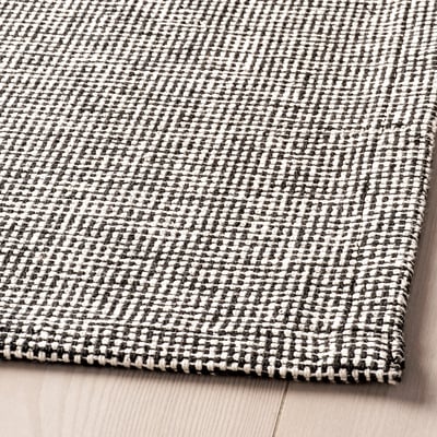 A TIPHEDE rug, rectangular, black and white, woven cotton.