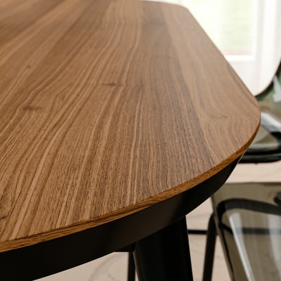 Wooden table with smooth, polished surface showcasing natural grain patterns. Supported by sturdy metal legs, indicating durability and stability.