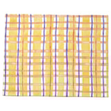 Bright yellow grid-patterned place mat with orange, white, and purple lines, rectangular shape.