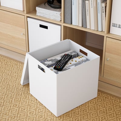 A white TJENA storage box with a handle, made of recycled paperboard, ideal for organizing media or hobby items.