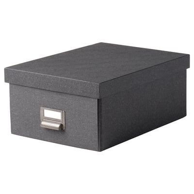 A TJOG storage box in dark grey with a metal label holder on one side. Its rectangular and made of recycled paperboard.