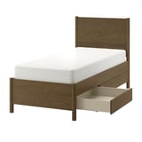 Brown wood TONSTAD bed with white mattress and open storage drawer.