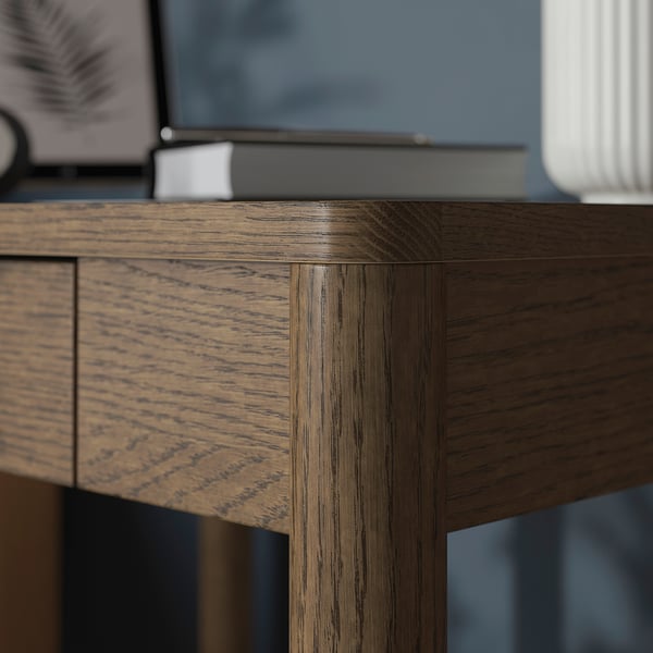 Close-up of well-crafted wooden desk showing smooth, durable veneer finish and sturdy joinery.