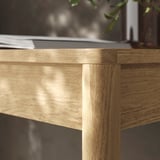 Well-crafted wooden desk with smooth, brushed oak finish, showcasing its sturdy construction and elegant design.