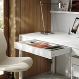 TONSTAD desk with open drawer showing stationery, light, and tablet