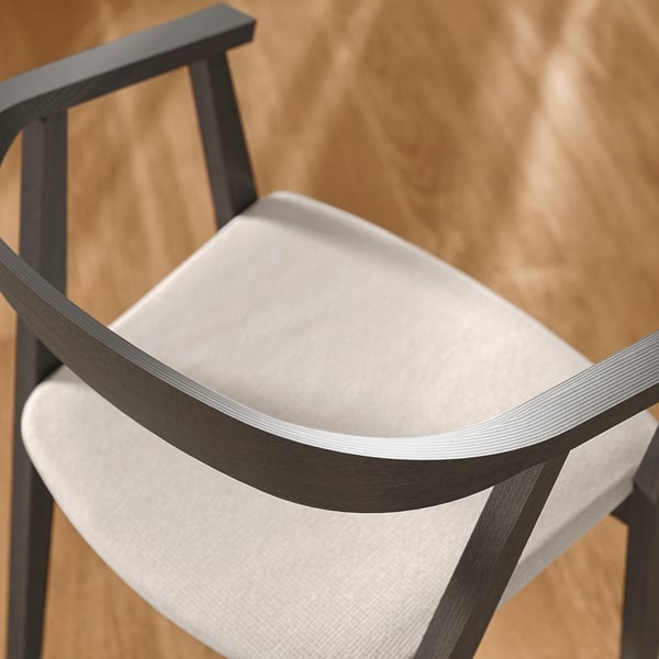 Modern chair with white cushion, dark wooden armrests, smooth edges, calm natural wood background.