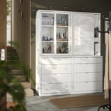 White TONSTAD storage unit with glass doors and drawers, displaying decorative items.