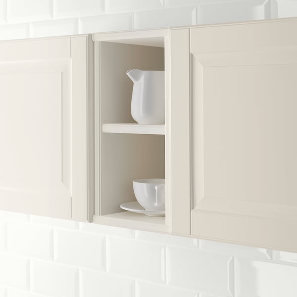 A cream-colored kitchen cabinet with open shelving holding white crockery, demonstrating accessible storage and display.