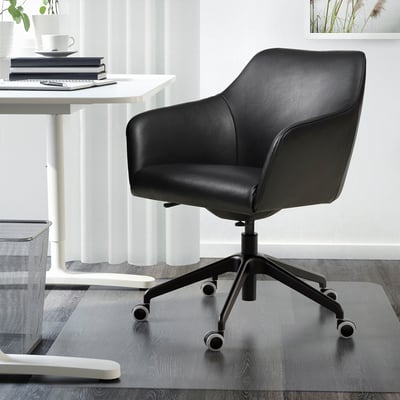 Black leather swivel chair with padded seat and back in minimalist office.