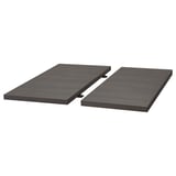 A black TRANEBO dining table with metal legs and a dark, rectangular top, designed for modern dining spaces.