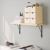 Wall-mounted wooden shelf holds books and decorative items, freeing floor space.
