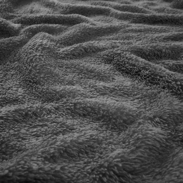 Close-up of soft, textured gray fleece blanket showing its thick, plush fabric.