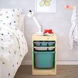 Nightstand TROFAST with teal bins, a lamp, and fox toy next to a patterned bed.