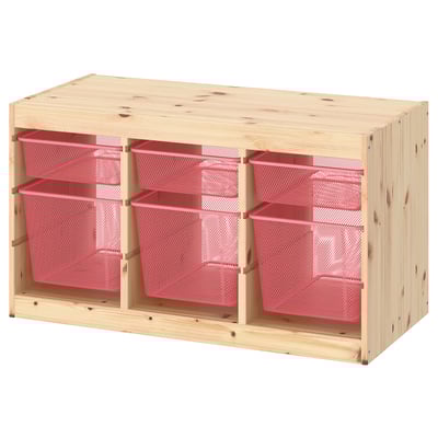 An ikea TROFAST storage unit in natural wood with red mesh bins, offering a versatile and customizable organization solution for teen rooms.