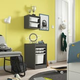 Yellow kids room with TROFAST storage, toys, gray chair, skateboard, sloth frame