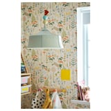 Colorful, patterned kids room with whimsical, tent-shaped green lamp hanging.